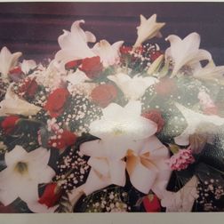 Coffin spray lillies and roses 4ft from £150. 5ft from £175